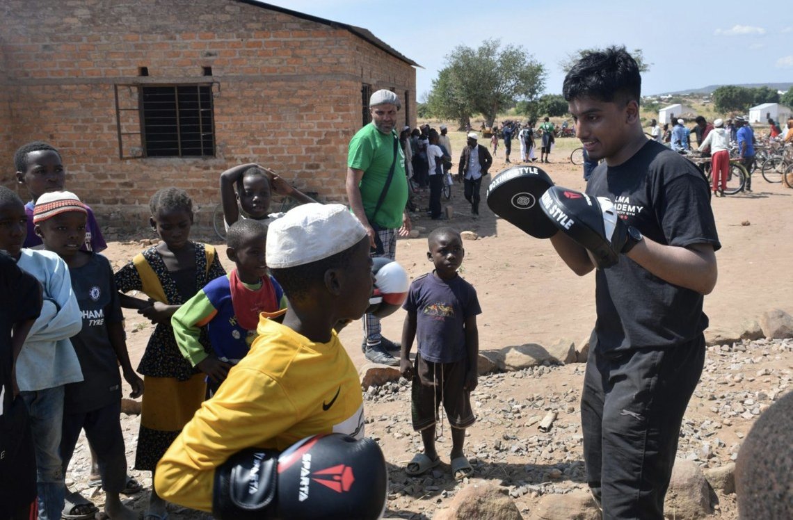 LMA Academy youth volunteer running a boxing session with children in Malawi